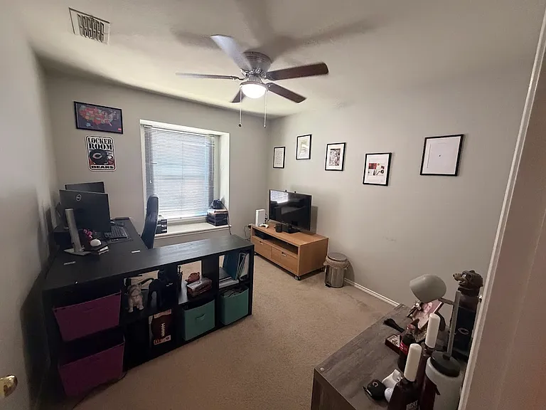 Room #3 with ceiling fan & a cute window seat.