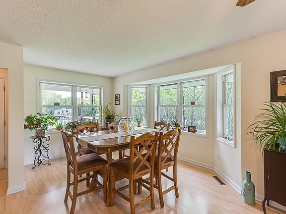 The spacious dining room is just off the front entry and has room to expand your dining room table and also has a bay window for your bird watching.