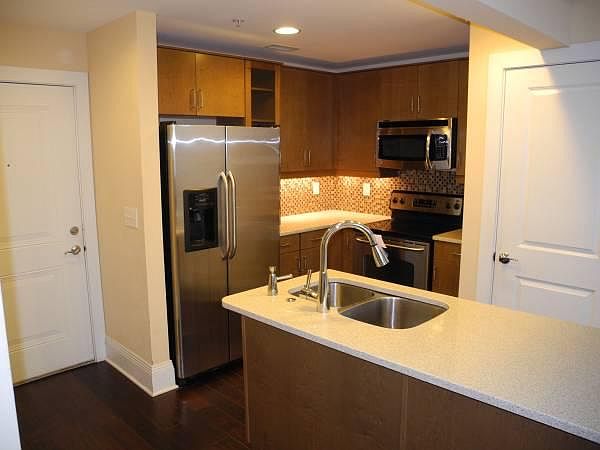 Kitchen with stainless steel appliances and quartz counterto