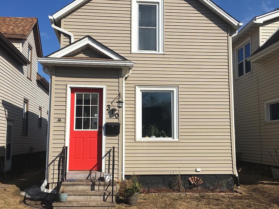 Street view of house. Spacious front lawn with low maintenance garden with perennial plants. New sidewalk and grass seed coming soon!