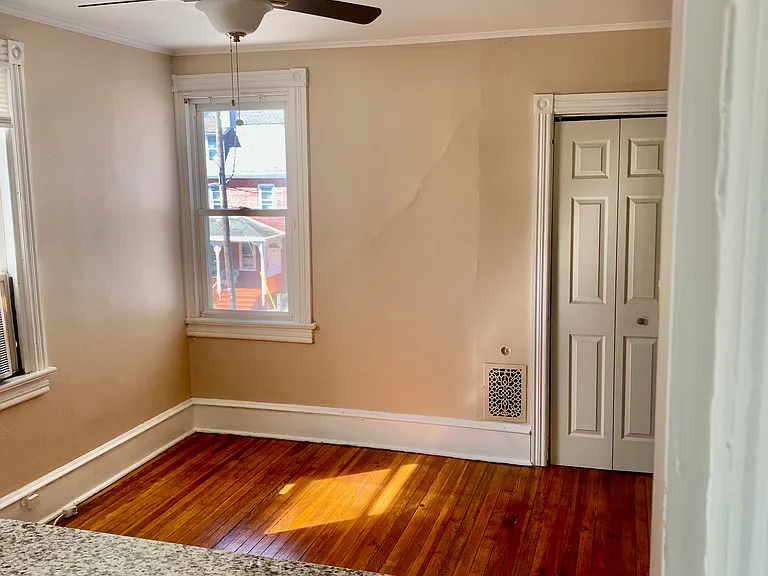 View of spacious dining room with plenty of natural light from inside kitchen overlooking the kitchen bar