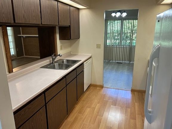 Kitchen looking into Dining Room ahead and Family Room on left seen from Pass Through over sink