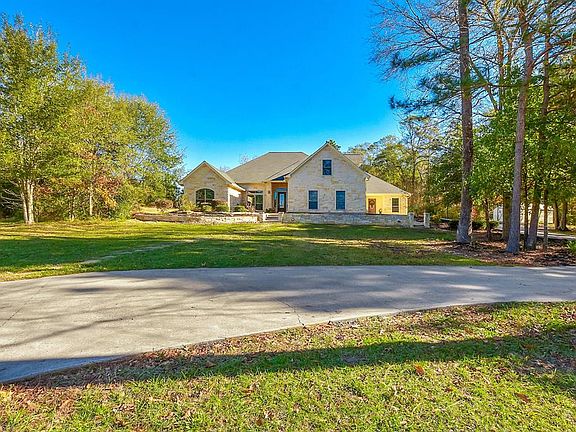 This view is from the long driveway looking at the front of the home.