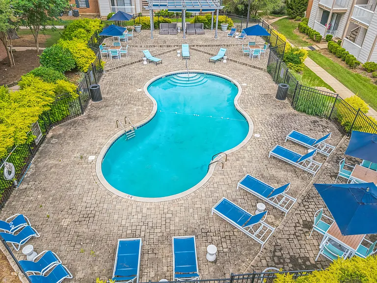 Unwind poolside with comfortable seating and shaded umbrellas in our relaxing pool area, professionally operated by Highlands Vista Group.