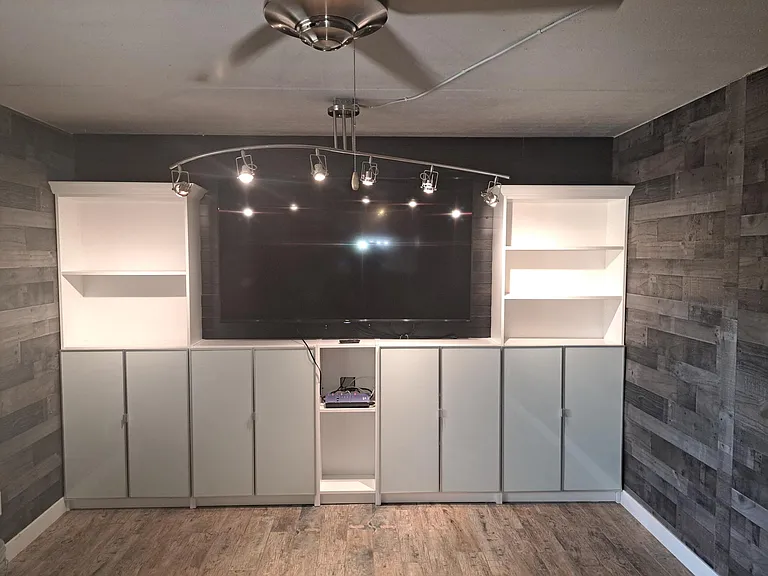 Living area with built in display and storage. Cable-ready 75" T.V. included.