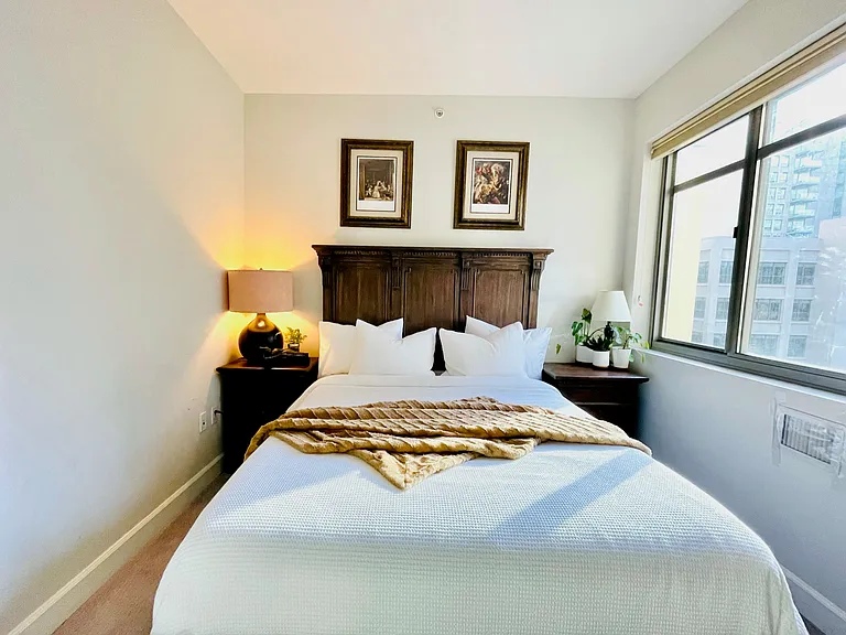 Second bedroom fits a queen bed and works well as a guest room or dedicated office space.