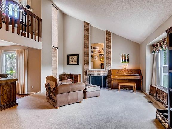 Front living room, just off foyer with fireplace and vaulted ceilings.