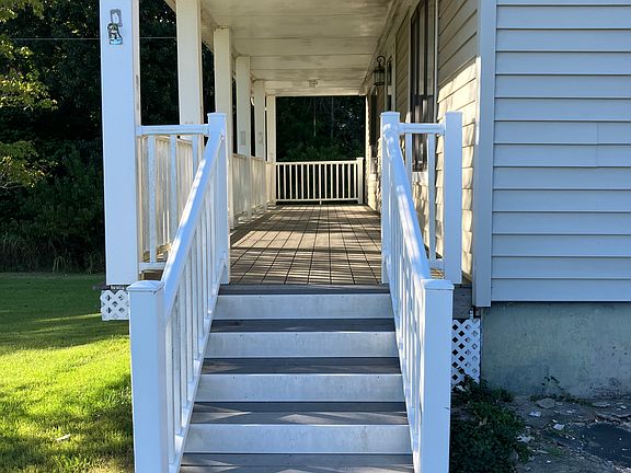 The stairs up to long front porch that spans the length of the house.