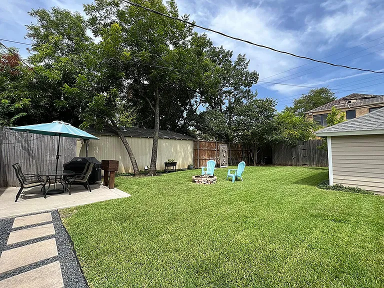 Large backyard with firepit, propane weber grill, and propane heater.
