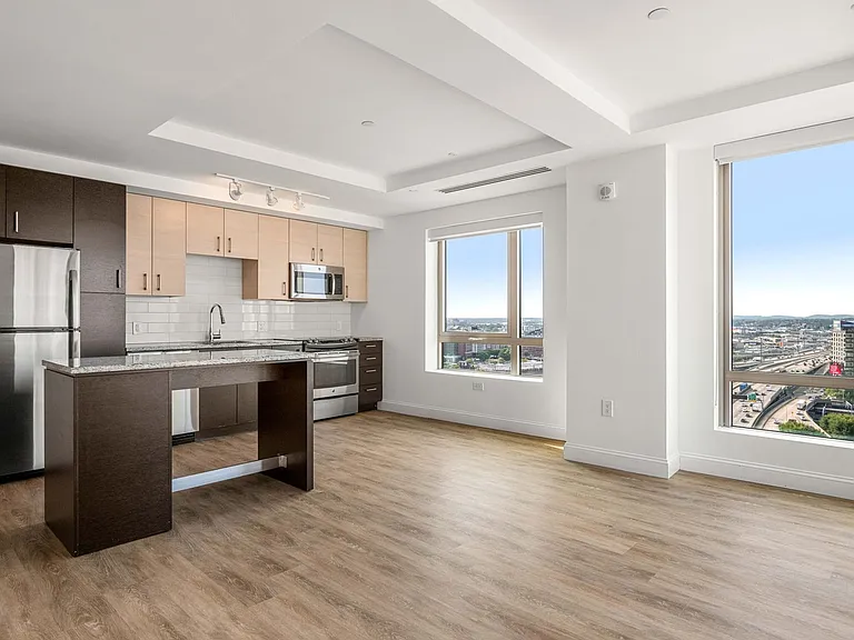 Open-layout kitchens feature stainless appliances and high-end fixtures throughout
