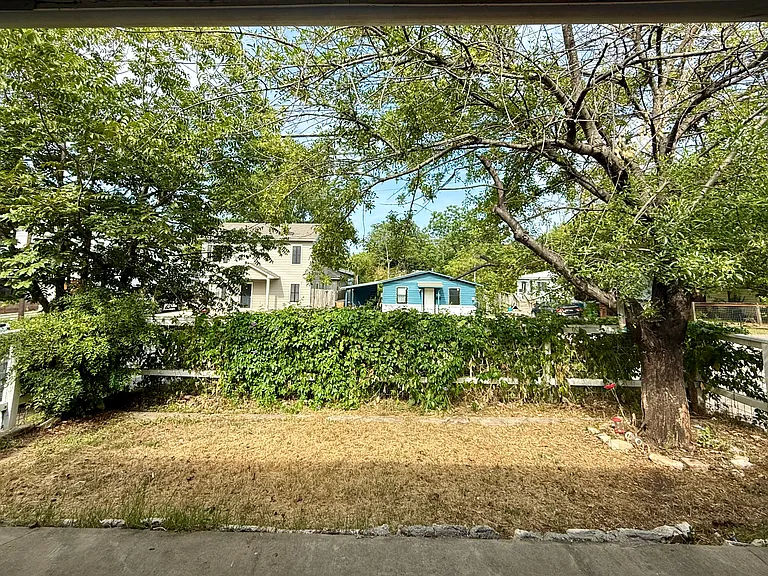 View from the porch looking out onto fully-fenced yard, with purple passion flowers and morning glories along the front fence, both for the pollinators and your privacy.
Landlord responsible for yard maintenance as needed.