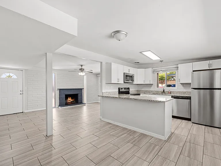 Bright, open main living area with tile flooring throughout.