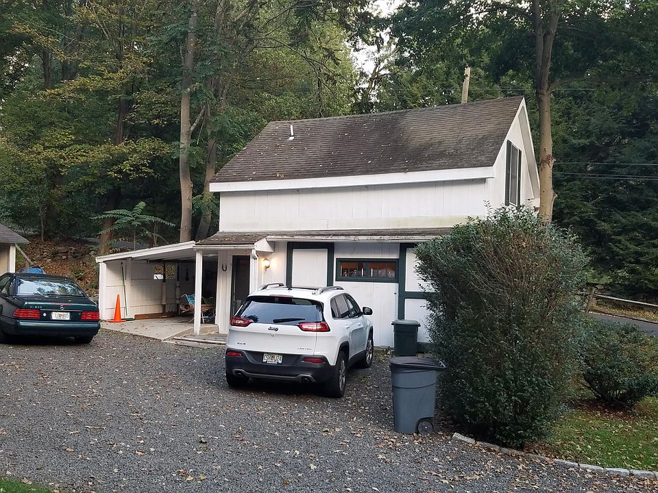 Front entry and parking area. Barn doors close or open to reveal window. Roof to be replaced.
