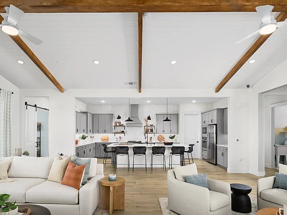 Great room with vaulted ceiling and stained ceiling beams