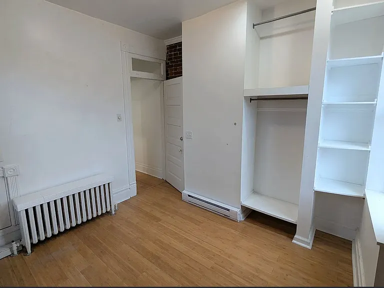2nd Floor 3rd Bedroom w/ exposed brick, two windows one: overlookng the garden, the other: the alleyway, built-in closet & shelves (featured here), fabulous, natural bamboo floors