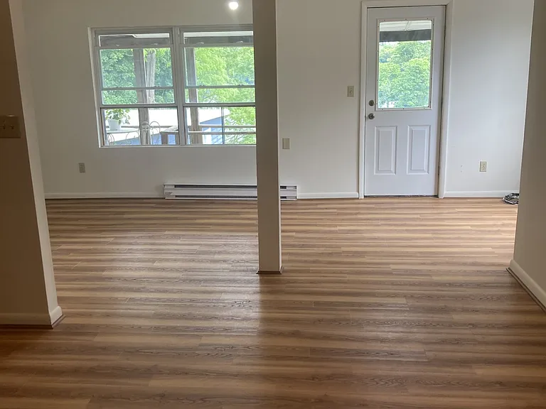 New paint & flooring throughout the apartment - this shows the living area from the dining area looking out onto the lake