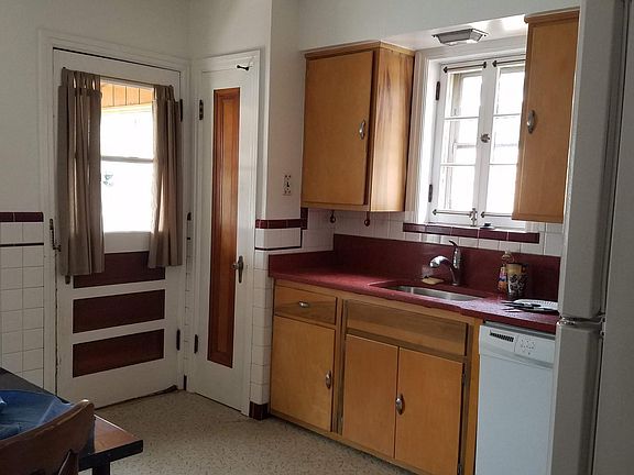 Kitchen with pantry and door to screened back porch.