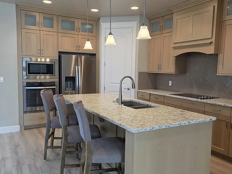 KITCHEN ISLAND WITH THREE BARSTOOLS INCLUDED.