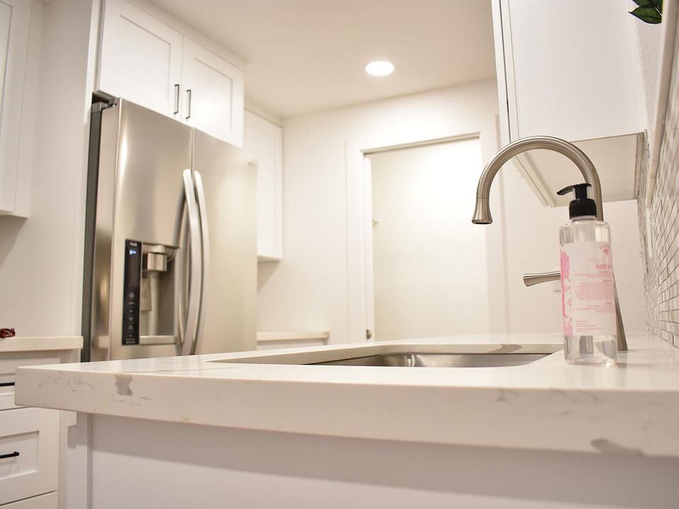 Kitchen's sink countertop towards storage room.