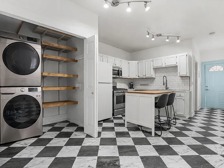 Updated kitchen with stainless steel appliances, bar seating, in-unit laundry, and ample storage.