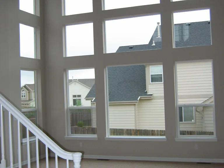 Living room. There are now plantation blinds on the lower windows.