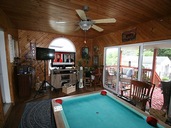 Enclosed porch/living room with pool table
