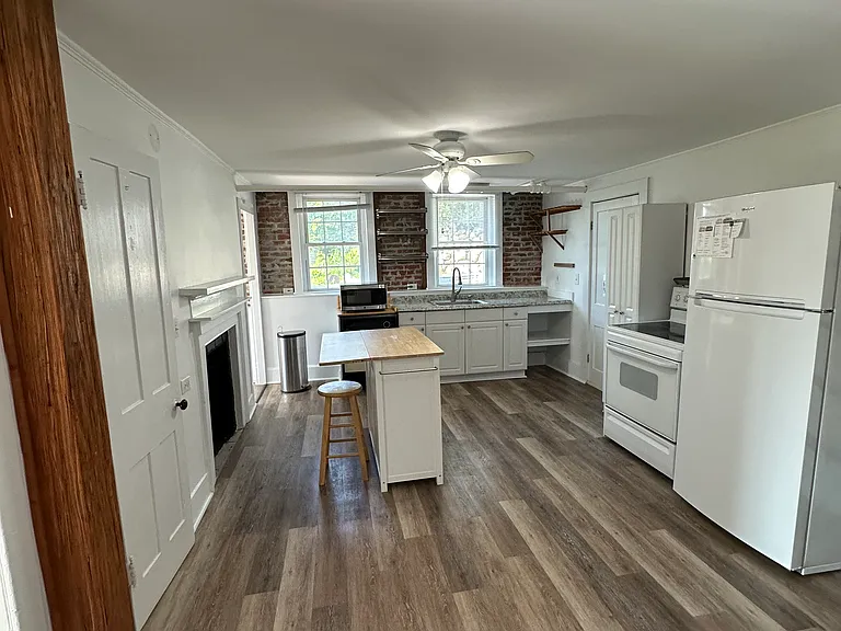 Large kitchen with full size refrigerator, electric stove, dishwasher and microwave. Pantry closet, 2 windows, exposed brick walls and island (I can provide a 4 person table that matches the island).