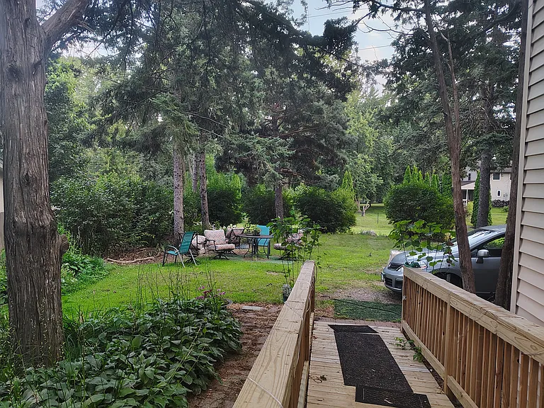 Standing at the top of the deck looking down the handicap ramp to the front yard.