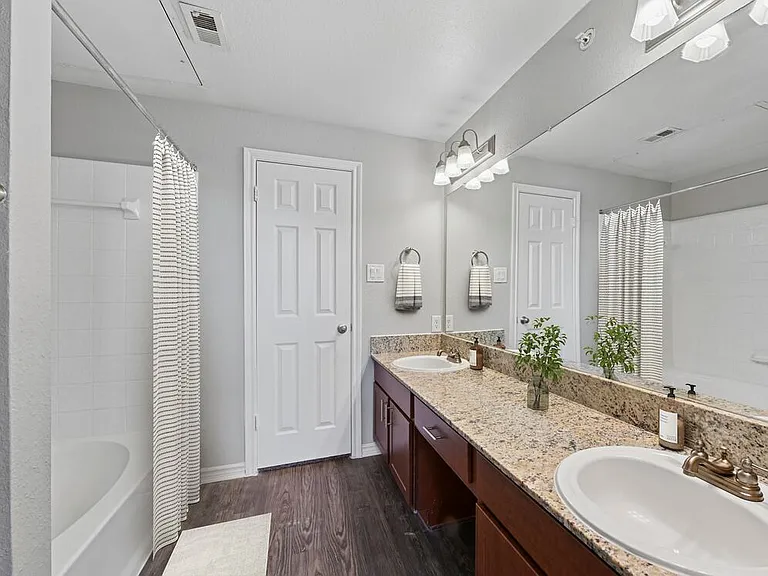 Classic Package I bath with chestnut cabinetry, speckled granite countertops, and hard surface flooring