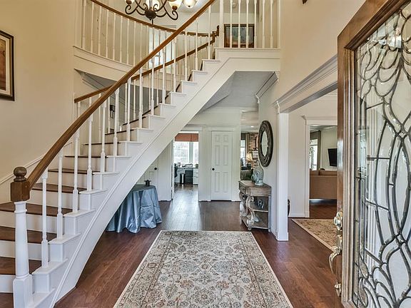 Wide open lovely entrance with floating stairway ascending to the second floor. Beveled glass front door adds elegance and sparkle to the entrance and by designs adds to your privacy.