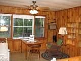 Knotty pine living room overlooks lake