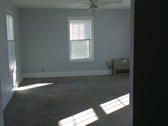 Master bedroom looking straight in. Two windows on the left, two windows on the right, one window straight on. River view of the Kennebec.