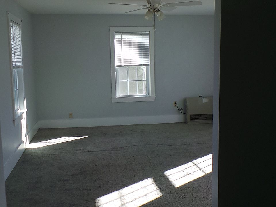 Master bedroom looking straight in. Two windows on the left, two windows on the right, one window straight on. River view of the Kennebec.