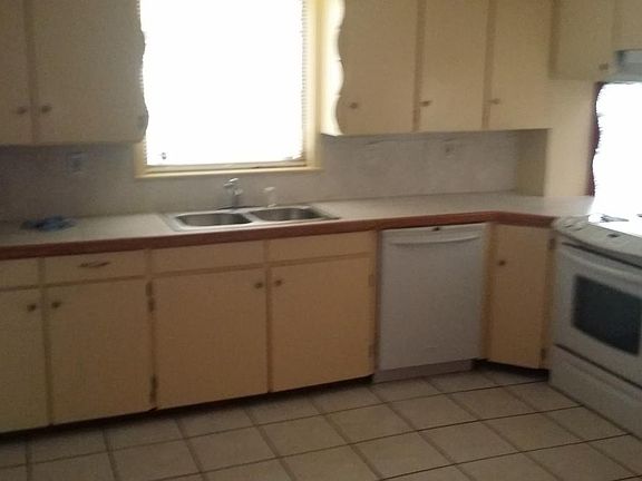 Kitchen with dishwasher, disposer and range