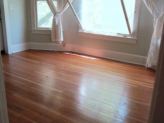 Living room without furniture. East-facing windows for great morning light.