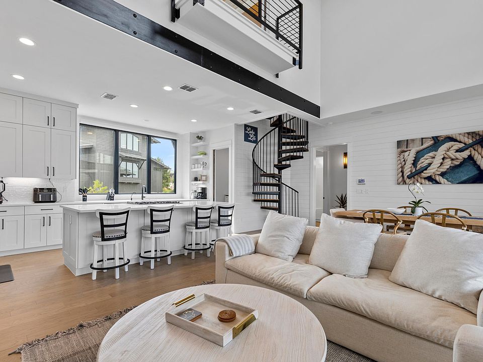 Open floor plan with light hues and soaring ceilings.