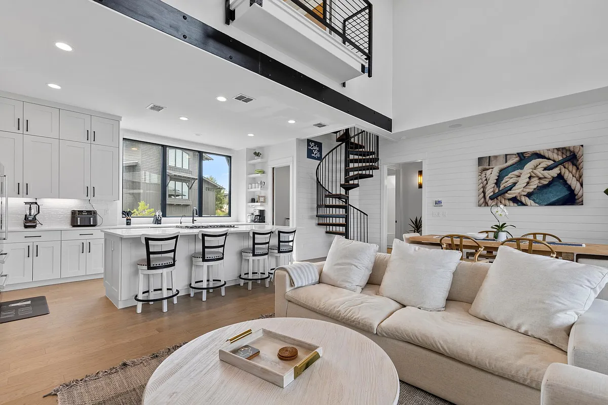 Open floor plan with light hues and soaring ceilings. - 19216 Lost Tree
