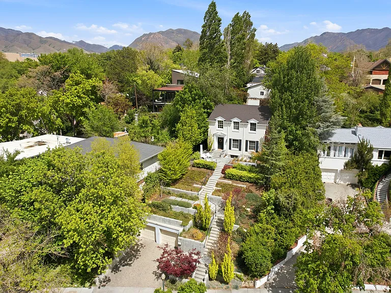 Quiet residential street in the prestigious "Harvard-Yale" neighborhood, 2 covered garage spaces in the front and additional huge 4 car garage from the back alley access. Beautiful landscaping and ultimate privacy at this home set up on a hill.