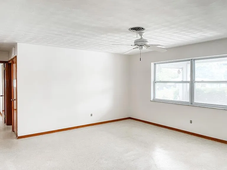 From the freshly-painted living room, you can go back the hallway to the 2 bedrooms. There are two spacious closets in the hallway.