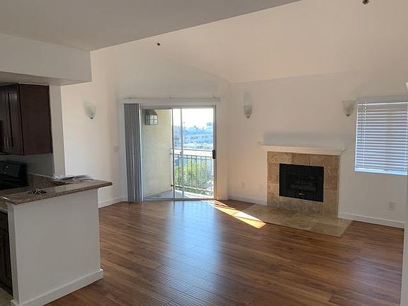 Spacious living room with working fireplace and balcony.