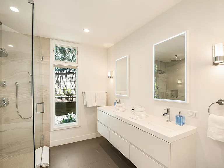 Indulge in luxury in the beautifully appointed bathroom, complete with a shower and all the essential amenities for a comfortable stay.