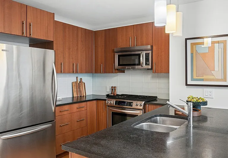 Elevate your cooking with Arbor's modern kitchen featuring sleek appliances, stylish cabinetry, and ample counter space. Perfect for culinary enthusiasts and entertaining guests. Explore your new home today!