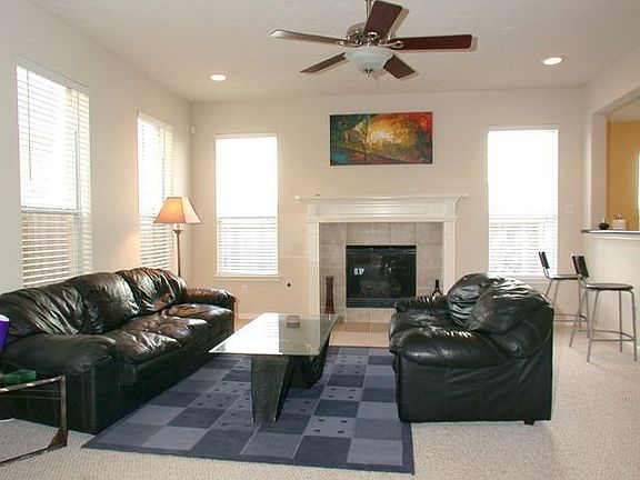Large family room with 2' blinds, gas fireplace with remote, updated lighting.