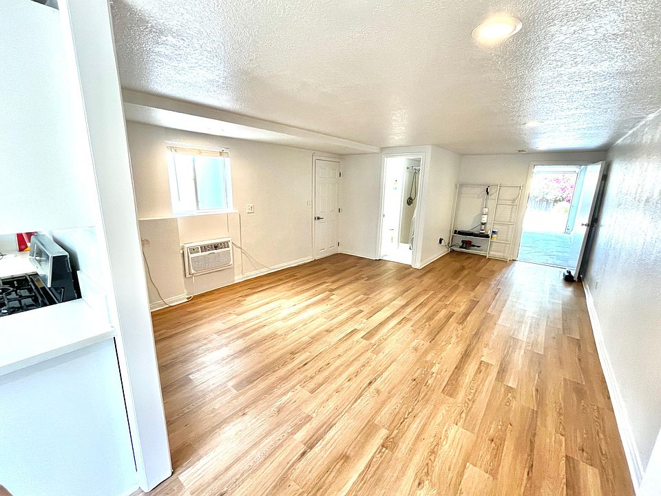 Studio Space - View from the kitchen. Entryway door on left, Bathroom in middle, attached Garage on right.