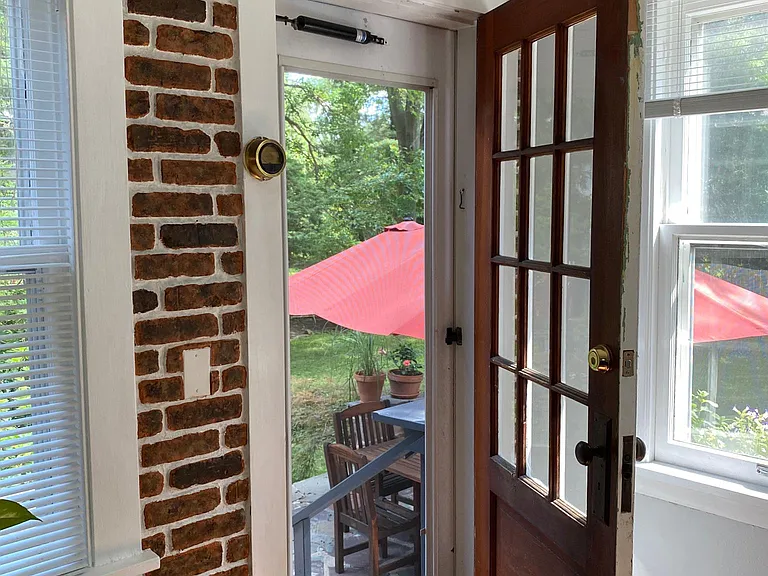 Kitchen opens to a beautiful stone patio that sits atop the backyard
