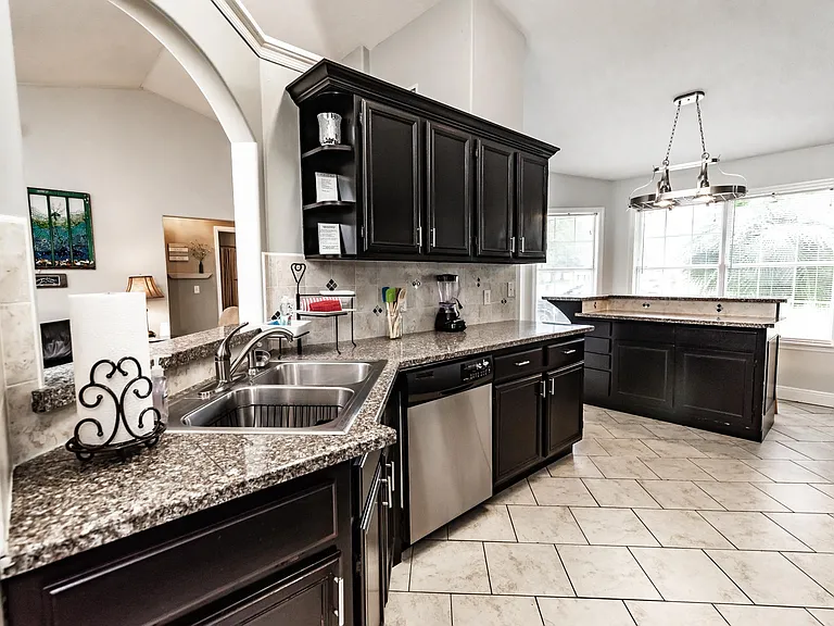 Granite and stainless kitchen with blender, crockpot, toaster, mixer, drip coffee maker and K-cup coffee maker, dishwasher, microwave and double oven.