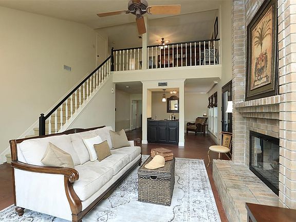 The family room flows into the formal dining space defined by a wet bar/serving counter.