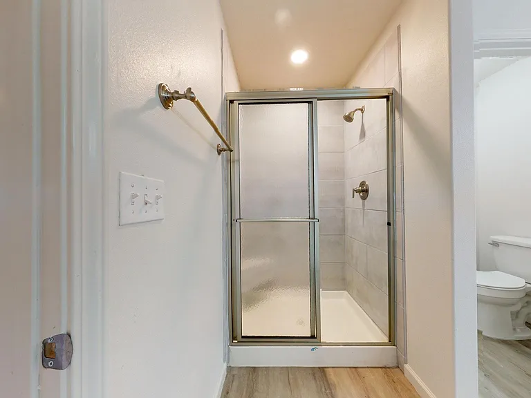 walk-in shower with shower seat in one master bath
