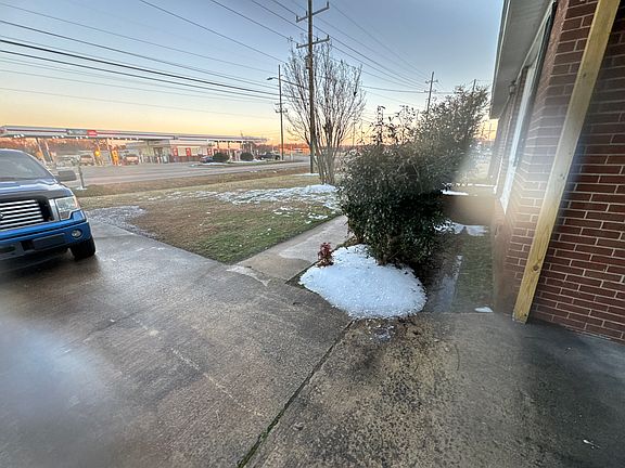 View from carport. concrete walkway to the front porch