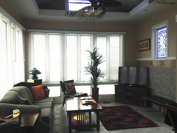 View of Living Room: smart TV, stained glass, and two walls